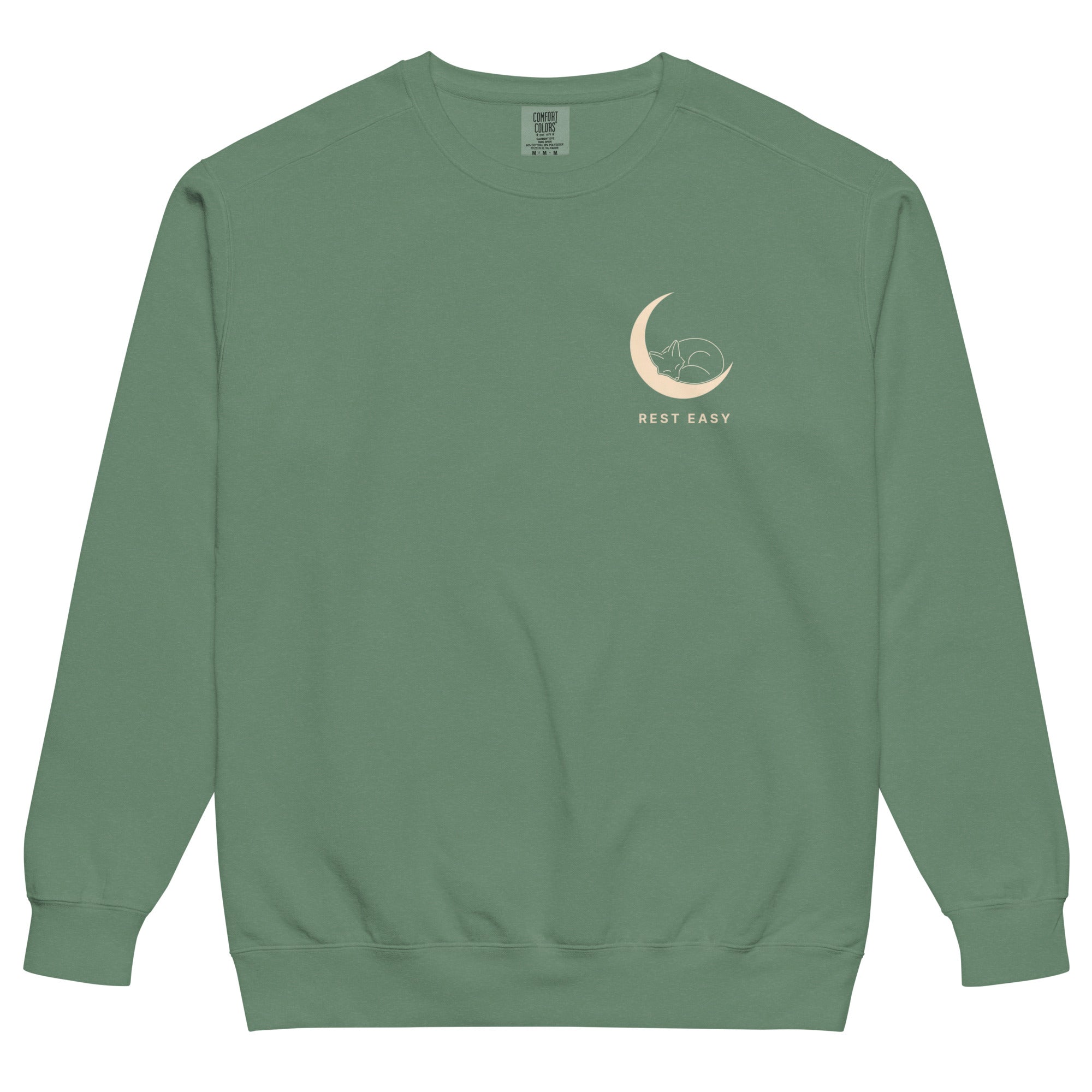 Sleepy fox in a crescent moon design on a Light Green garment-dyed sweatshirt